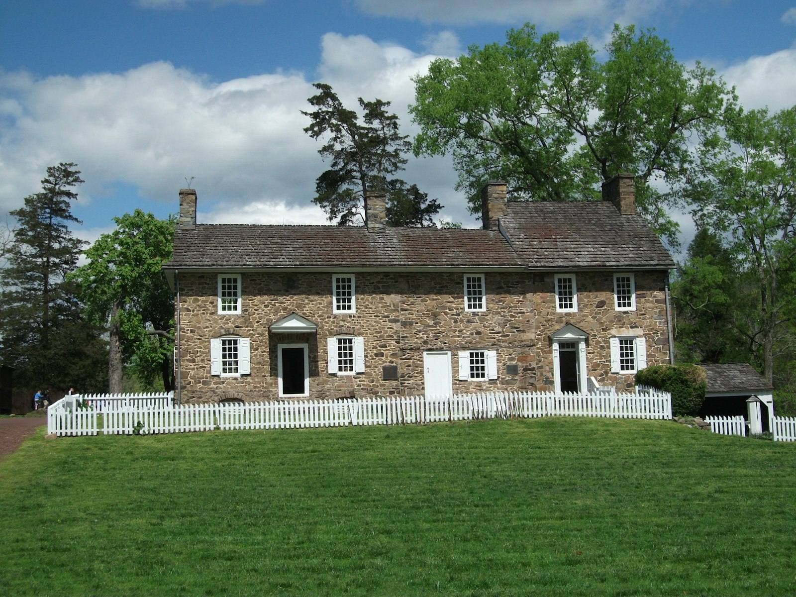 Pennsylvania stone house with picket fence. Montgomery County appeal guide.